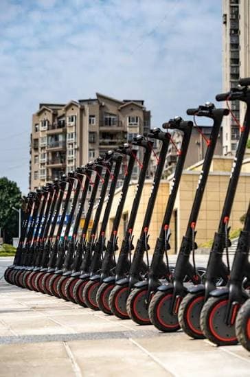 Fleet of electric scooters parked in a city street
